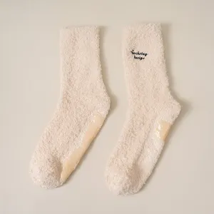 Cozy plush fuzzy winter warm slouch socks with anti-slip sole and stylish embroidery.