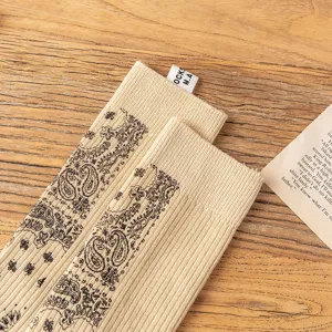 Detailed close-up of vintage paisley printed cotton socks, showcasing exquisite retro pattern and texture.
