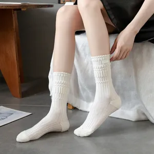 Detail view of women's thick loop knit long socks with dark stripes and stylish label.
