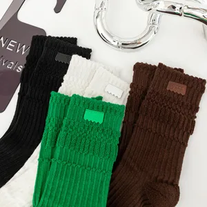 Thickened loop long socks with custom leather labels, comfortable autumn winter casual hosiery.