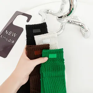 Thickened terry long socks with custom leather labels, comfortable autumn winter socks.