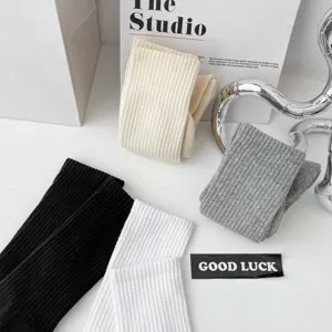 Close-up detail of casual ribbed cotton socks in assorted solid colors, soft texture.