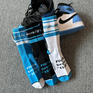 Unisex streetwear mid-calf cotton socks with stylish 1985 text and university blue stripes.