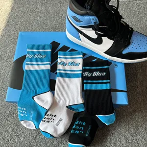 Detailed view of UNC blue street style crew socks, matching sneaker aesthetic for casual wear.