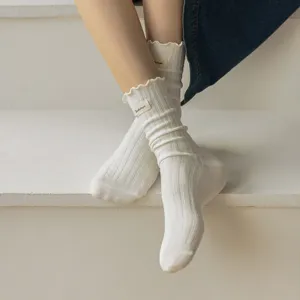 Women white ribbed slouchy socks detail shot, sweet lettuce edge cotton mid tube sock closeup.