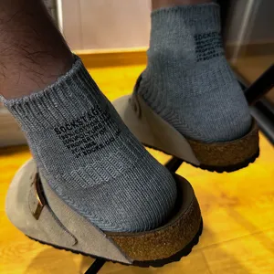Detail shot of grey ribbed cotton socks with stylish letter print, comfortable everyday wear.