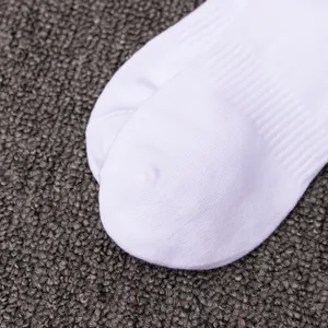 Close up view of white cotton sports sock detail, showing breathable ribbed knit texture.