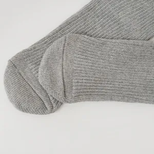 Grey ribbed knit sock toe detail, soft cotton texture, minimalist style close-up shot.
