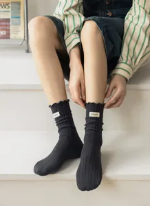Detailed view of women's cotton slouch socks featuring sweet lettuce edge and rib knit design.