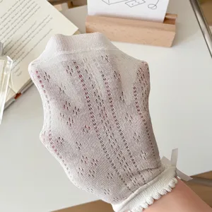 Close-up detail of women's hollow out mesh short socks with cute bow at ankle, breathable.