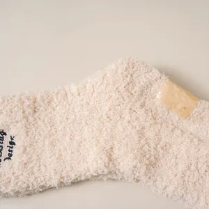 Cozy plush fluffy warm winter slouch socks for women with cute letter embroidery detail.