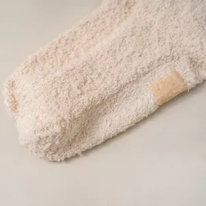 Close-up detail of cozy plush winter socks showing soft fleece texture and subtle side label.