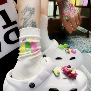 Trendy mid-calf cotton socks with colorful embroidery and graffiti letters for men and women.