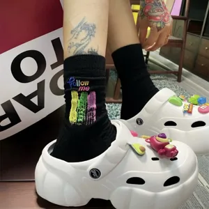 Trendy black cotton mid-calf socks with colorful embroidery and graffiti letters for men and women.
