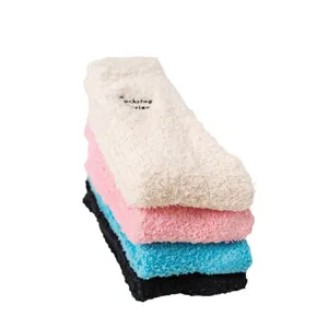 Plush fluffy fuzzy warm winter slouch socks stacked in four colors with cute embroidery.