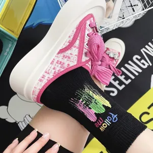 Chic thick-sole casual sneakers paired with trendy embroidered black socks for women.