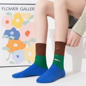 Detail shot of women colorblock distressed socks, stacked mid-tube design, soft cotton fabric.