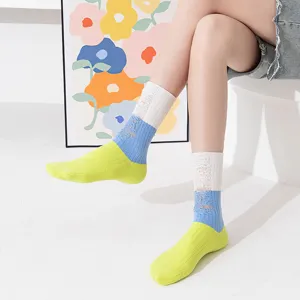 Close up detail of women color blocked distressed socks showing unique cutouts and soft fabric.