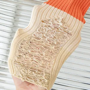 Close-up of color-block distressed knit socks showing unique laddered details and texture.