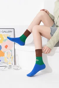 Detailed view of women colorblock distressed mid-calf socks in white studio showcase.