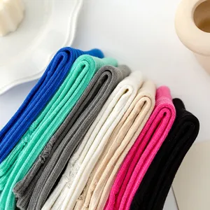 Detailed close-up view of multi-color ribbed mid-tube socks stacked neatly for daily wear.