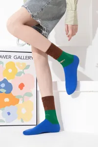 Women's color block distressed mid-calf socks showcasing unique ripped details and vibrant contrast.