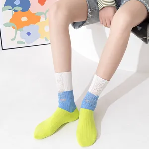 Detail shot of women's color-blocked distressed mid-tube socks featuring unique ripped and contrast design.
