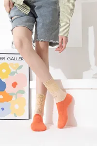 Details of women's color-blocked distressed socks, featuring contrast hues and ripped design.