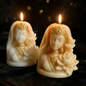 Detailed close-up of sculpted goddess scented candles with gold details and lotus flower design.