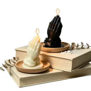Praying hands scented candles set, aesthetic black and white wax decor for cozy home interior.