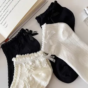 Detail view of women short socks with lace ruffle and bow, soft cotton for summer.