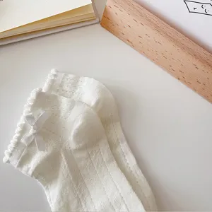 Cute white women's short cotton socks with sweet bow and breathable hollow design.