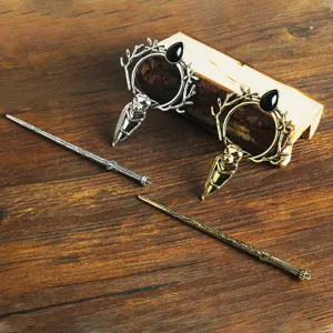 Detailed view of retro viking hair pin featuring deer antler and raven design with black gem.