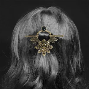 Vintage metal hair pin with leaf design and black stone, perfect for retro bun styling.