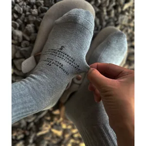 Men casual streetwear crew socks with letter print, breathable cotton long socks, grey detail view.
