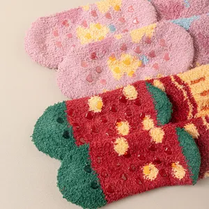 Close-up view of fluffy winter coral fleece socks with cute non-slip silicone grip soles.