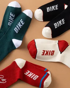 Detailed view of stylish cotton crew socks featuring bold BIKE lettering and contrast colors.