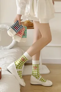 Cute plaid mid-calf socks with sweet red bow embroidery for women and girls daily wear detail.
