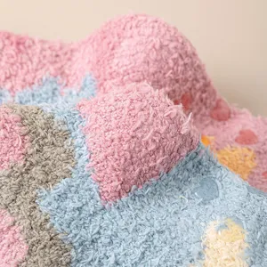 Plush fuzzy socks detail view, soft coral fleece winter warm floor socks with grips.