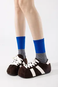 Close-up detail of stylish color-block mid-calf socks featuring a textured knit design.