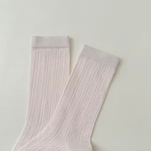Close-up detail of women pink vertical striped breathable mesh mid-calf socks texture