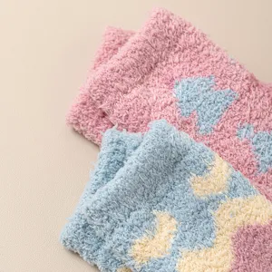Close-up view of soft coral fleece socks detail, showing cozy winter warm plush texture fabric.