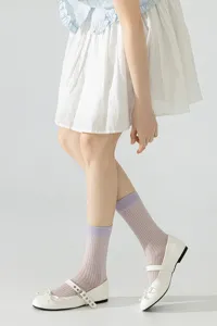 Details of ultra-thin sheer mesh mid-tube socks with delicate ribbed cuffs, ballet style.