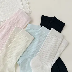 Close-up detail of solid color ribbed mesh mid-tube socks in various pastel shades for daily wear.