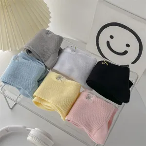 Women cotton mid-tube socks with cute bow embroidery, comfortable stacked design for daily wear.