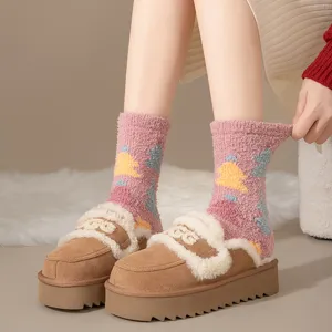 Close-up view of cozy pink fuzzy Christmas socks paired with brown platform slippers.