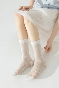 Detail view of ultra-thin sheer mesh mid-calf socks with ribbed cuffs for women.