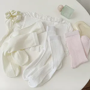 Close up of women white and pink breathable mesh mid tube socks with vertical stripes details.
