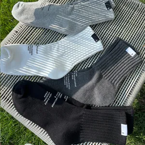 Casual sports solid color cotton mid-tube socks with custom letters and stylish design.
