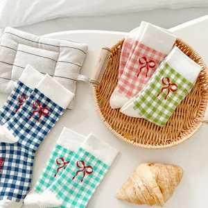 Chic plaid mid-tube socks featuring cute red bow details, soft cotton fabric, cozy daily wear.